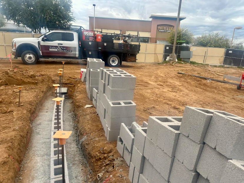 Father and Son Masonry truck on site during CMU retaining wall construction at Bikini Beans Coffee Scottsdale AZ