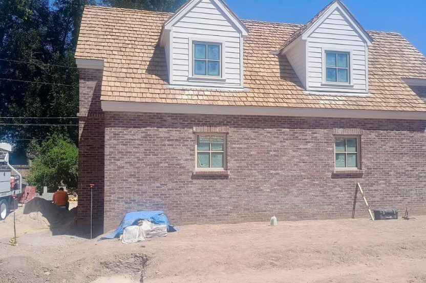 Before photo of dark brick masonry installation on residential home exterior in Phoenix AZ by Father and Son Masonry