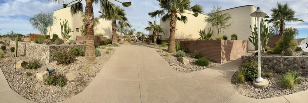 Panoramic view of finished concrete pathways and brick masonry walls at Grass Clippings Rolling Hills Arizona