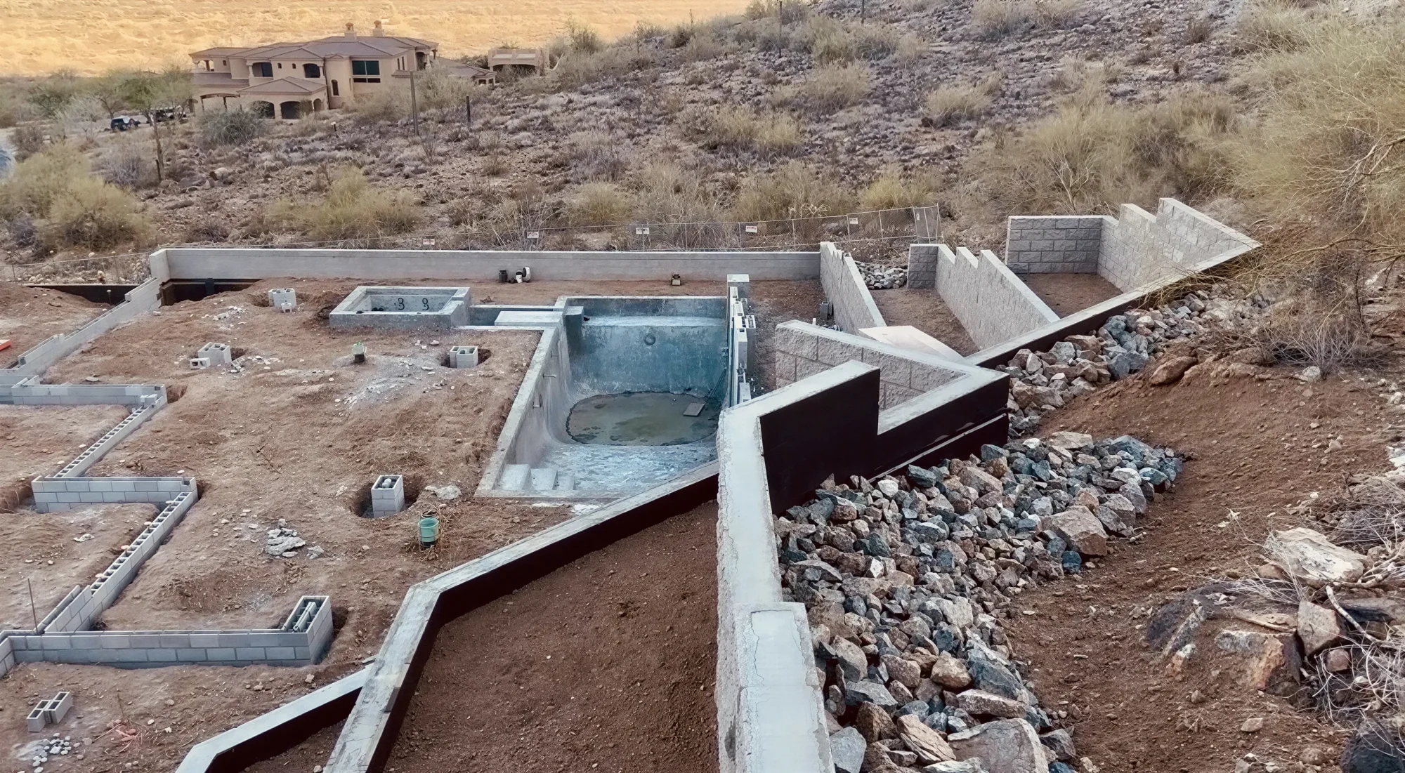 High quality aerial view of structural CMU retaining walls on steep hillside lot in Phoenix AZ