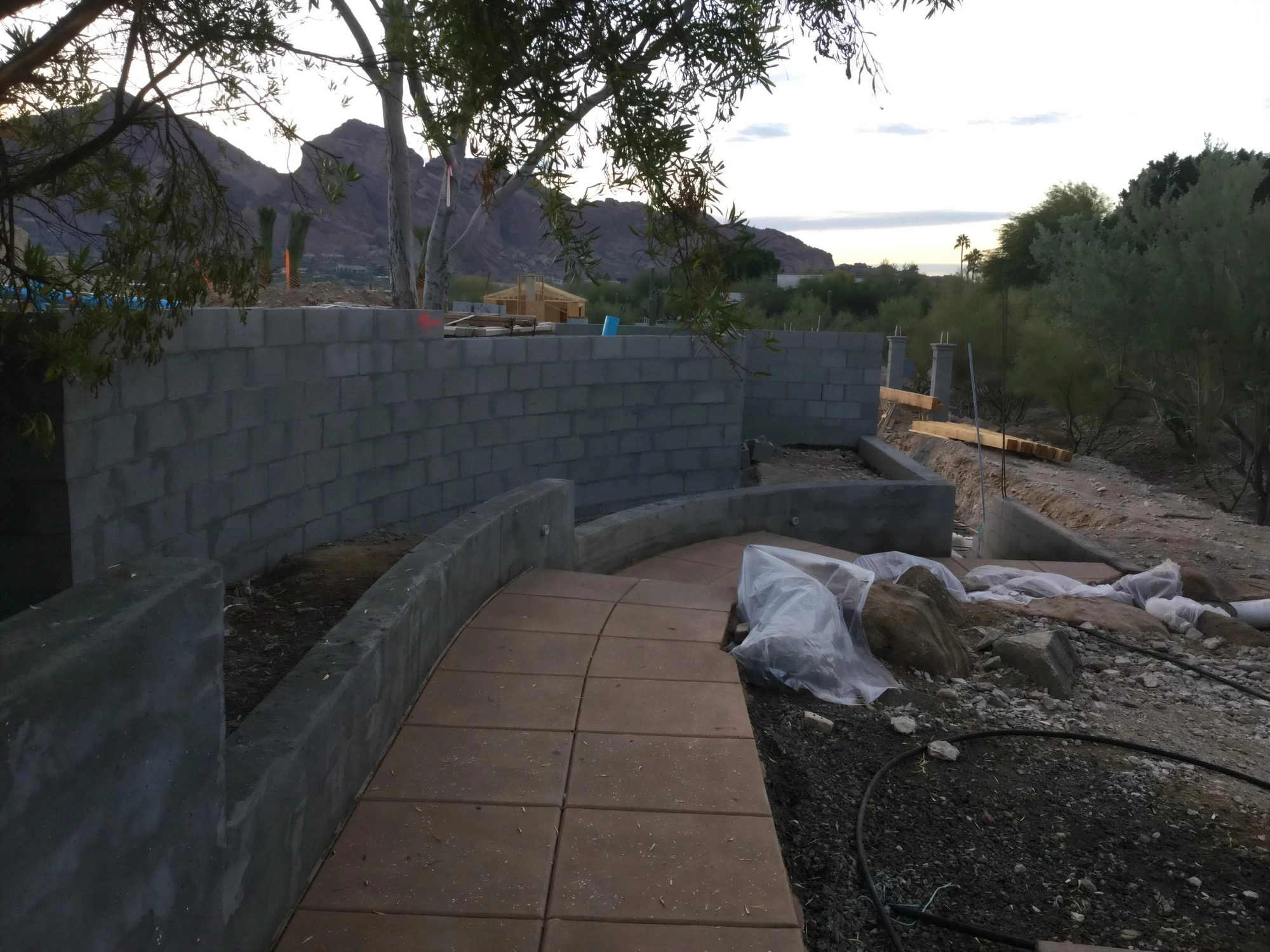 Aerial view of hillside CMU retaining wall construction with waterproofing and pool area Phoenix AZ