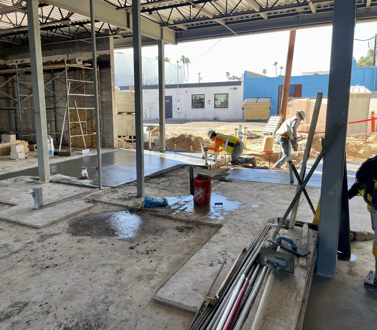 Father and Son Masonry crew pouring interior concrete slab at Reformed Pilates renovation in Old Town Scottsdale AZ