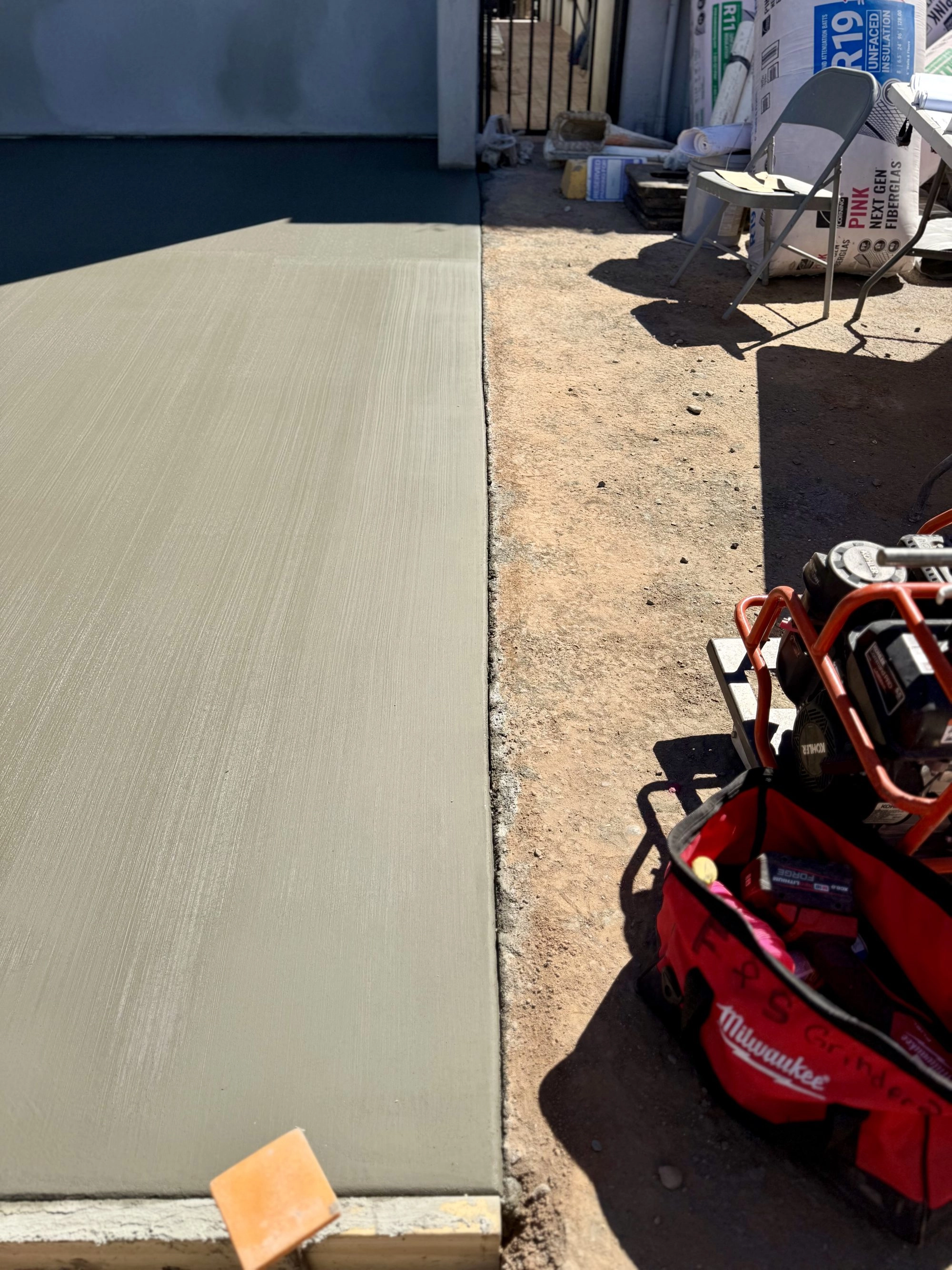 Freshly poured broom finish concrete flatwork at Reformed Pilates commercial project in Scottsdale AZ