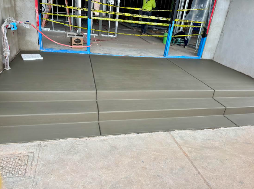 Newly poured smooth concrete entry steps at Reformed Pilates studio renovation Old Town Scottsdale AZ