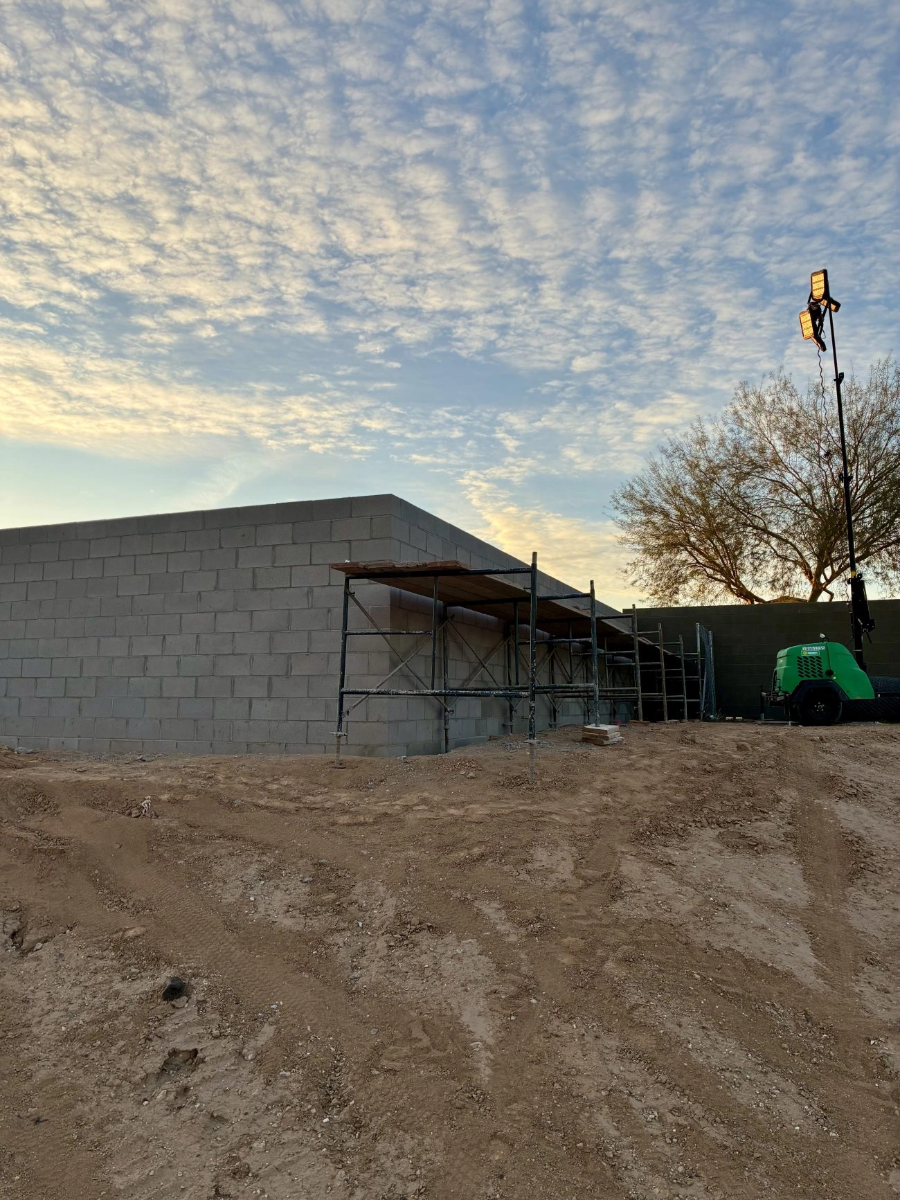 CMU block masonry wall under construction at Sunbelt Rentals facility in El Mirage Arizona at dawn