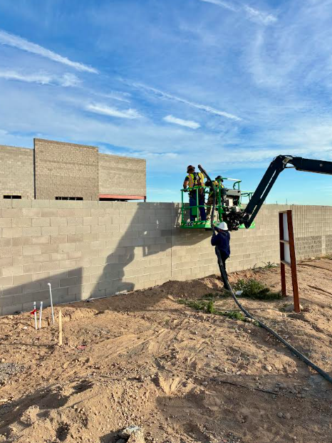 Father and Son Masonry team posing at Sunbelt Rentals CMU block construction site El Mirage AZ