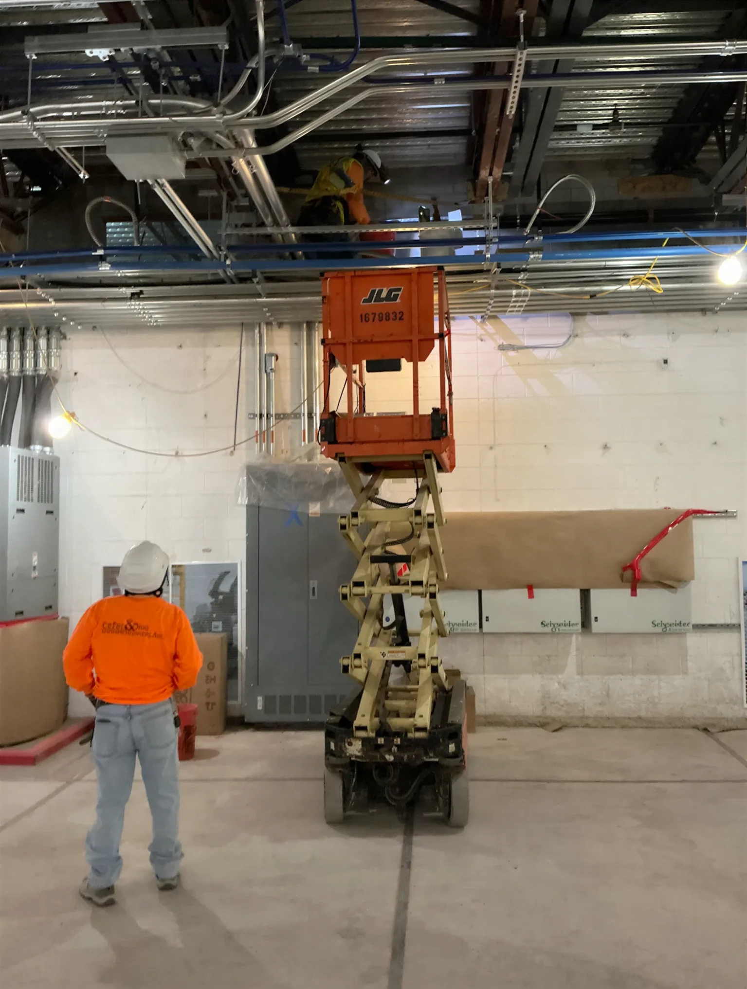 Father and Son Masonry worker on scissor lift doing interior masonry work at T-Mobile Data Center Phoenix AZ