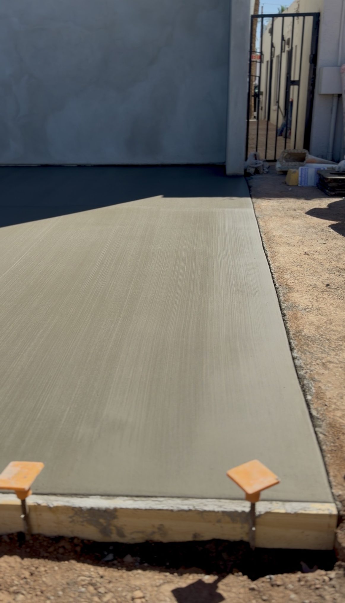 Wide angle view of completed concrete flatwork pour at Reformed Pilates Scottsdale AZ by Father and Son Masonry